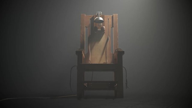 Wooden electric chair in the foggy room spotlight. Camera slow pan. 4K HD