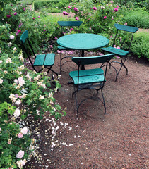 Summer rain in the garden.  Outdoor table and chair in green color.