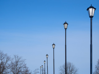 Street lamps against the blue sky