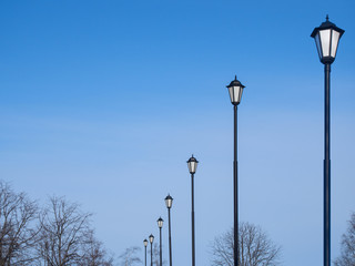 Street lamps against the blue sky