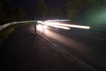 Traffic at Night - White Light Trails on a Highway Corner - Long Exposure