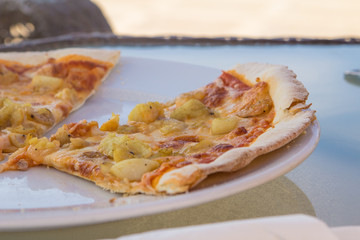 slise of pizza with shrimps on a plate.