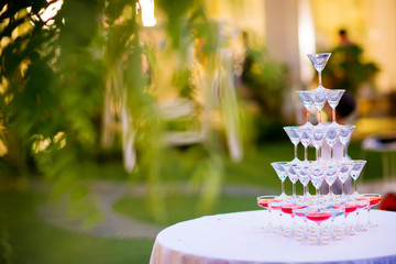 Champagne glass pyramid.pyramid of glasses of wine, champagne, tower of champagne's glass in wedding reception party