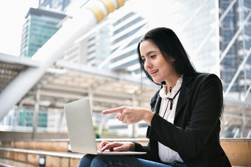 Business concept. Young businesswoman is working in business district. Young businesswoman happy to work.