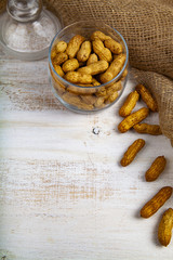 Peanuts in an open glass jar
