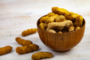 Peanuts in a wooden bowl