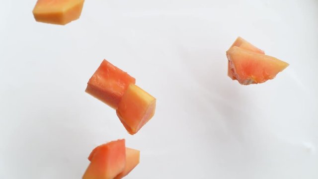 Camera follows tossing cut papaya in milk. Overhead shot. Shot with high speed camera, phantom flex 4K. Slow Motion.