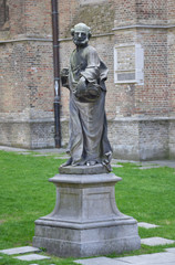 Statue in front of church of Our Lady in Bruges, Belgium