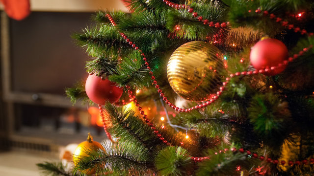 Beautiful image for winter celebrations with decorated Christmas tree against fireplace