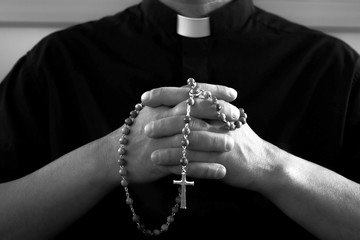 Priest with rosary beads