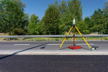 Surveyor measuring equipment (theodolit) on construction site - obrazy, fototapety, plakaty