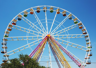 Colorful ferris wheel on blue sky background in Luna Park.