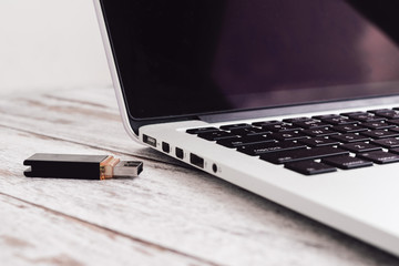 Woman hand entering inserting usb flash into laptop computer