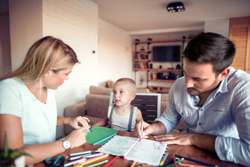 Young parents with child draw