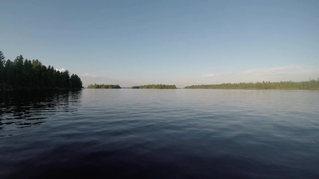 Smooth Water in Rainy Lake Rolling Under Moving Boat