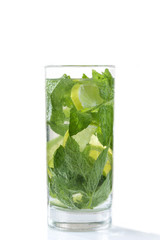 Detox drink. Cold and refreshing detox water with lime, mint leaves , and ice in glass jar. White background Copyspace