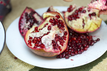 tasty pomegranate on a white plate