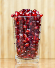 pomegranate berries on a glass beaker