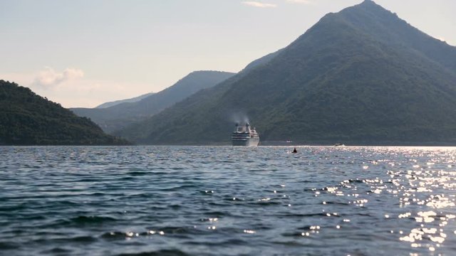 White cruise liner in the Bay of Kotor. Sunny day in Montenegro.