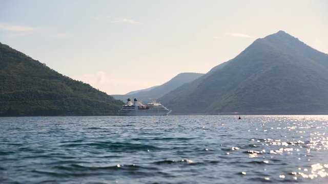 White cruise liner in the Bay of Kotor. Sunny day in Montenegro.