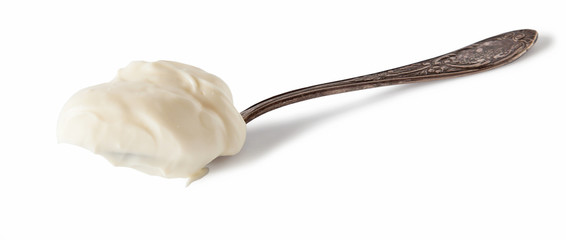 Spoon with cream cheese. Isolated on white background. 