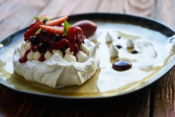 Pavlova Cake with Whipped Cream, Raspberry Jam and Assorted Fruit and Berries, sweet dessert pavlova