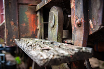 Vintage rusted wooden stair tread of an old carriage exterior on urbex shunting platform, authentic industrial details and craftsmanship along the rail way and station