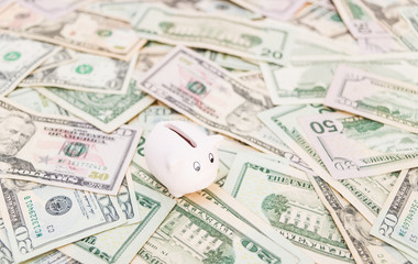 Piggy bank with a lot of American Dollars; investment and banking concepts