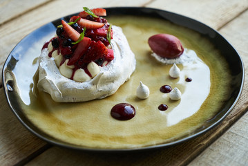 Pavlova Cake with Whipped Cream, Raspberry Jam and Assorted Fruit and Berries, sweet dessert pavlova
