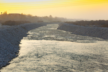 the flow of water on the river during a beautiful sunset