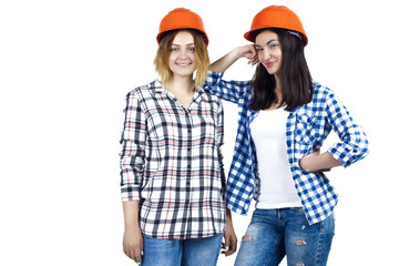 Two happy funny cute architects female woman girl in orange construction protection building helmets on isolated background. Design architecture studio concept