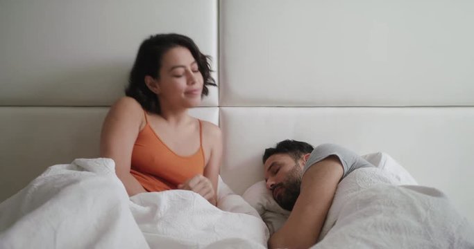 Woman Trying Sexual Approach With Man In Bed At Home
