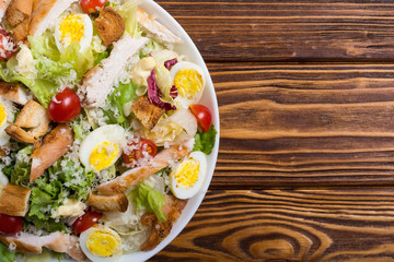 Salad ceasar with chicken , eggs and tomatoes