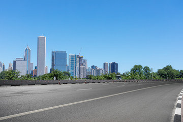 Fototapeta na wymiar asphalt highway with modern city in chicago