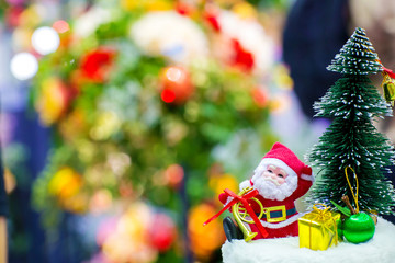 Focus christmas toy, santa claus decoration with blur background. christmas festival. giving season and family time. funny holidays for kids. image for background, wallpaper, objects and copy space.