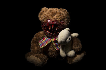 a terrible bear on a black background with a cute bear in his hands