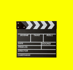 Fototapeta na wymiar Movie clapper isolated on yellow background. clapper board film. slate cinema film with clipping path. cinema production. image for background, wallpaper, objects and copy space.