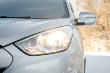 car on nature with headlights on