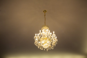 Huge crystal glass chandeliers hanging on ballroom dance in wedding ceremony date,decorated by victorian style