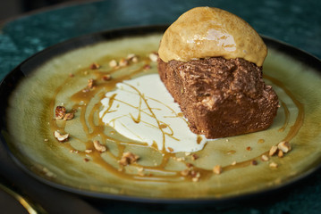 Chocolate dessert fondant with a liquid and pistachio ice cream, close-up
