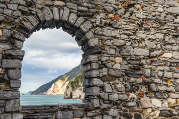Sea view from a stone window of an old ruin castle wall in Portovenere, Liguria, Italy.