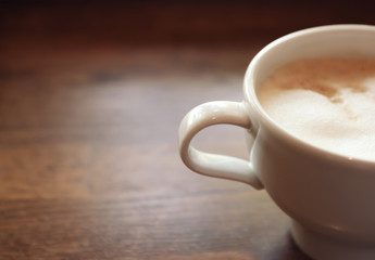 Cup of fresh aromatic coffee on table, closeup