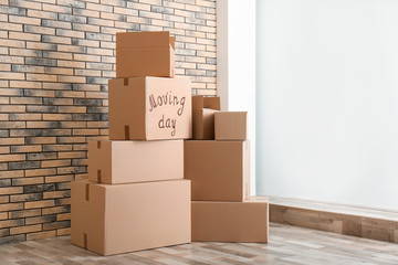 Pile of moving boxes in empty room