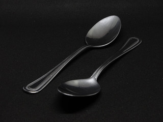 Metal spoon on black backgroud