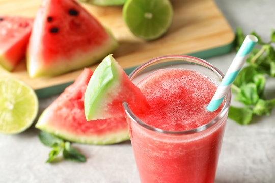 Tasty summer watermelon drink in glass on table, closeup