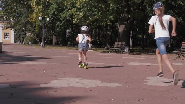 Children are playing in the park. Sisters compete for speed.