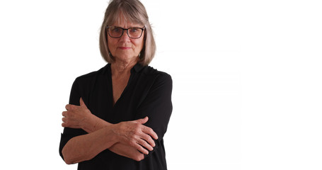 Lovely mature woman with stern look crossing arms one white copy space