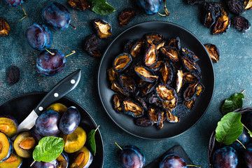 Dried prune and fresh plums with leaves
