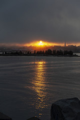 Sun silhouetting New Bedford waterfront