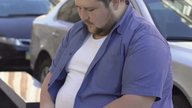 Insecurities, overweight male sitting on bench alone, inferiority complex